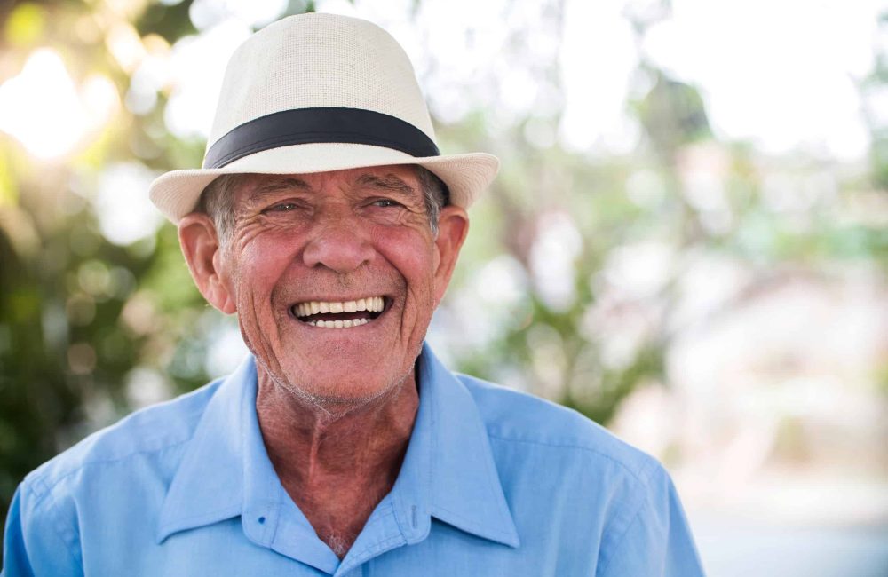 Portrait,Of,Senior,Brazilian,Man,With,White,Hat,Looking,At