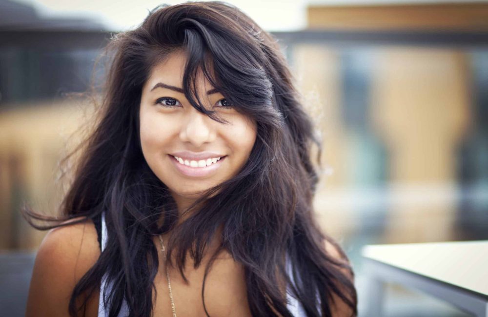 Beautiful,Spanish,Woman,Smiling,At,The,Camera,Isolated,On,White.