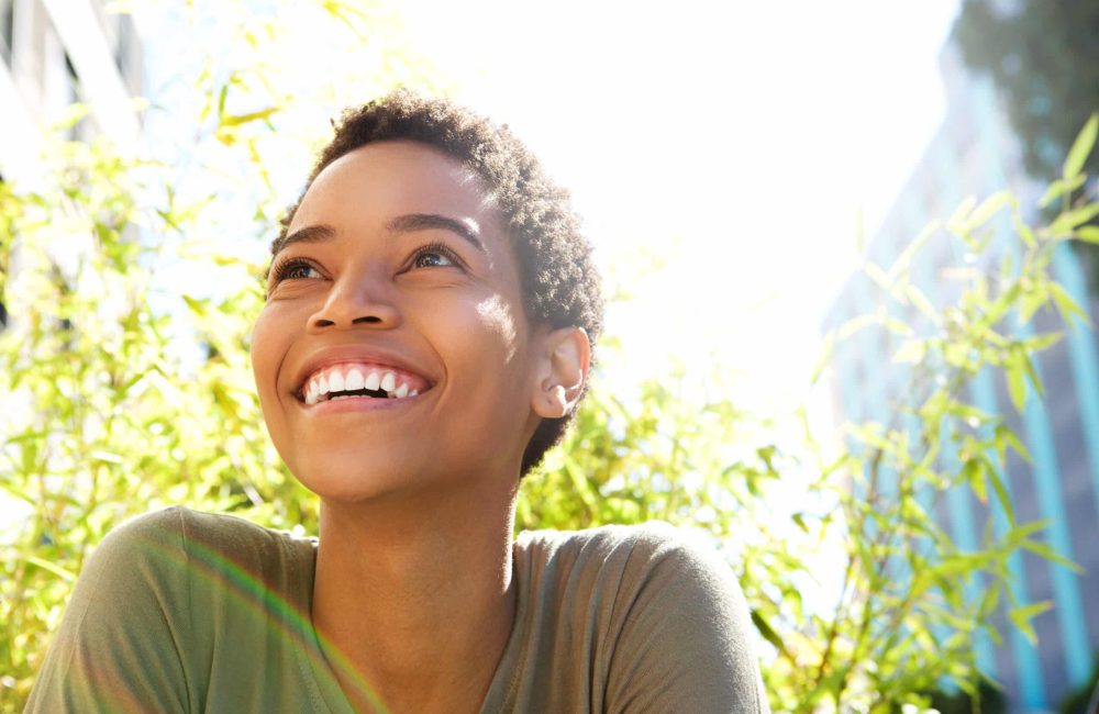 Close,Up,Portrait,Of,Beautiful,Young,Black,Woman,Smiling,Outdoors